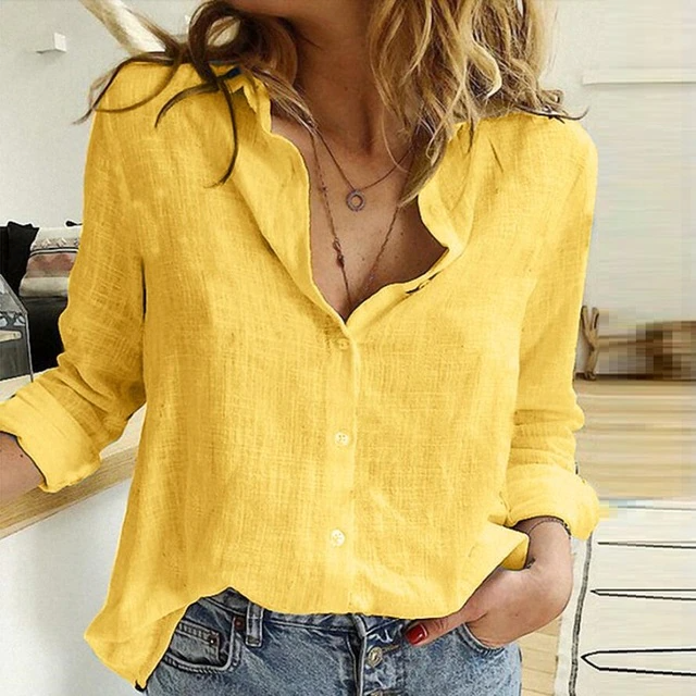 Yellow shirt worn by a person with a blurred indoor background