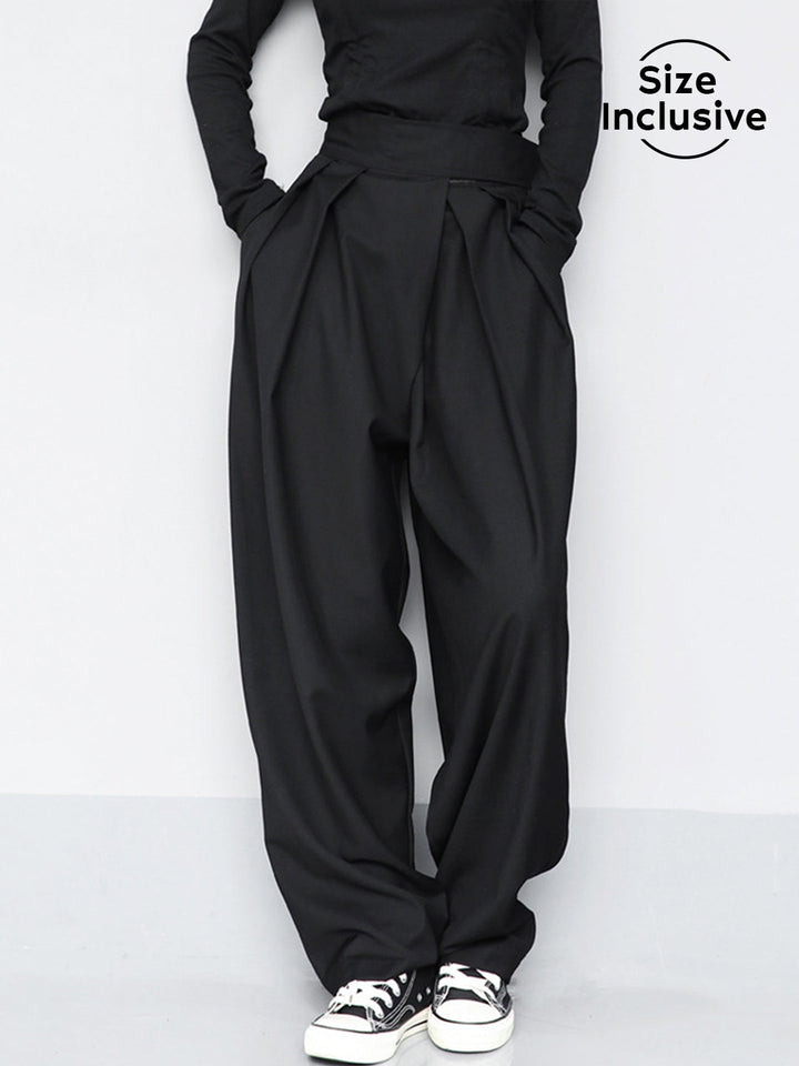 Person wearing black wide-leg pants and a black top on a white background with 'Size Inclusive' text.