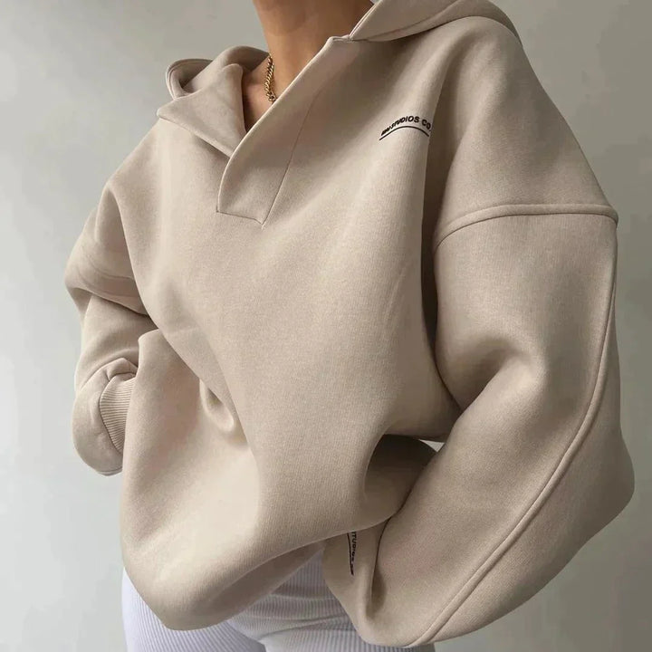 Beige hoodie worn by a person on a plain background