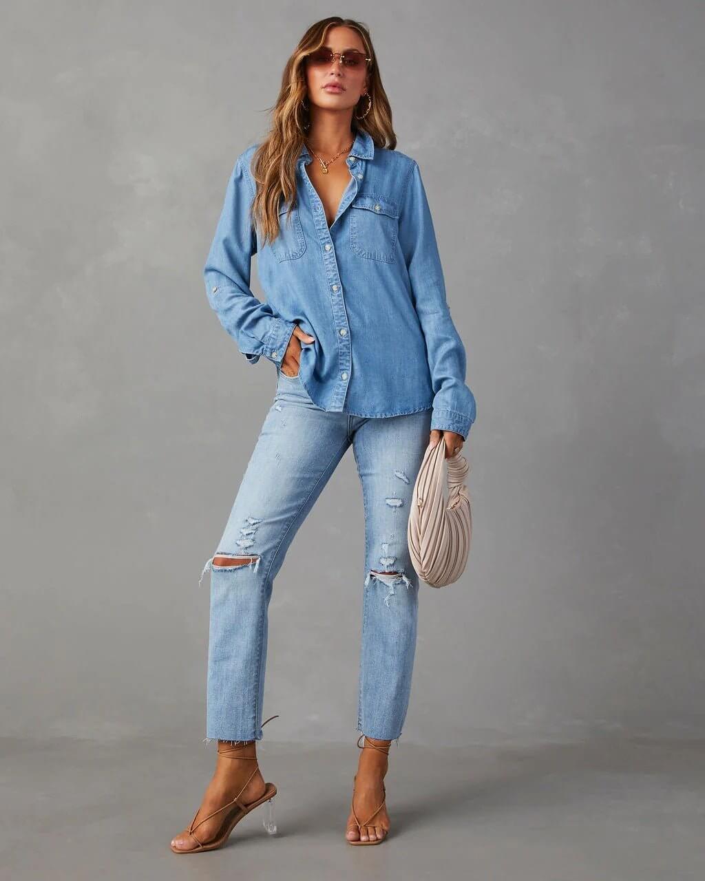 Person wearing a denim outfit against a gray background